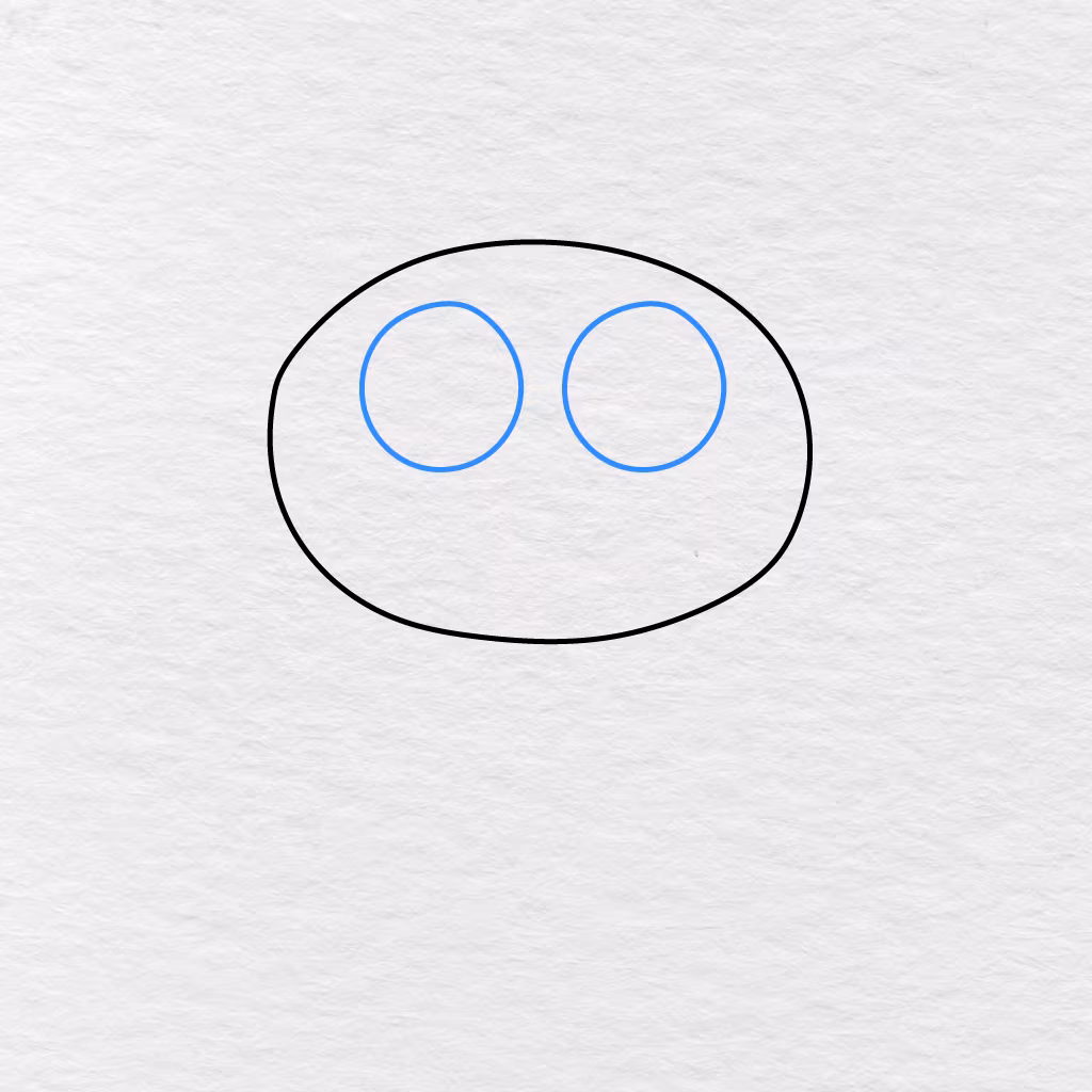 Step 2 Showing Two Large Round Eyes Added Inside The Cat’s Head.